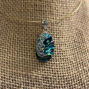Abalone shell pendant set in sterling, silver with sterling silver details 1.25”